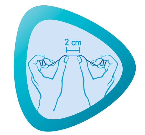 Niebieskie kółko z dwiema rękami trzymającymi nić dentystyczną